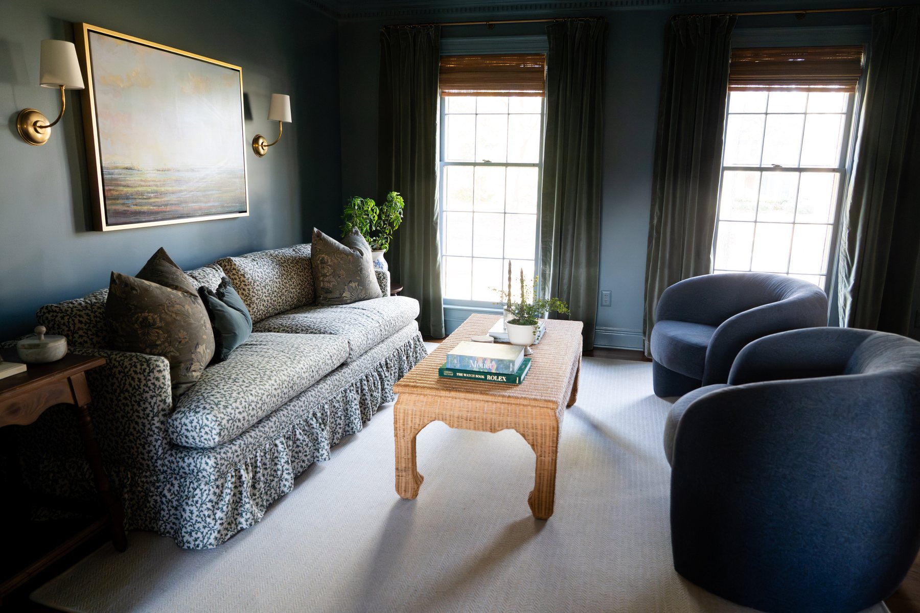 Rattan coffee table in a moody blue Charleston living room